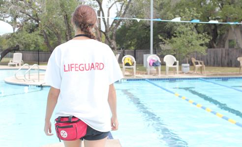 Lifeguard on duty
Senior Lauren Frank walks up and down the aisle of the pool at the South Austin YMCA swimming pool. With a whistle around her neck and first-aid bag at her side, she is prepared for anything to happen at any moment. Frank has been life guarding since the beginning of summer and continues working in the lifeguard career, taking things seriously.“I take my job very seriously because I know that a drowning can happen at any moment and ultimately it’s up to me to do my job right,” Frank said.