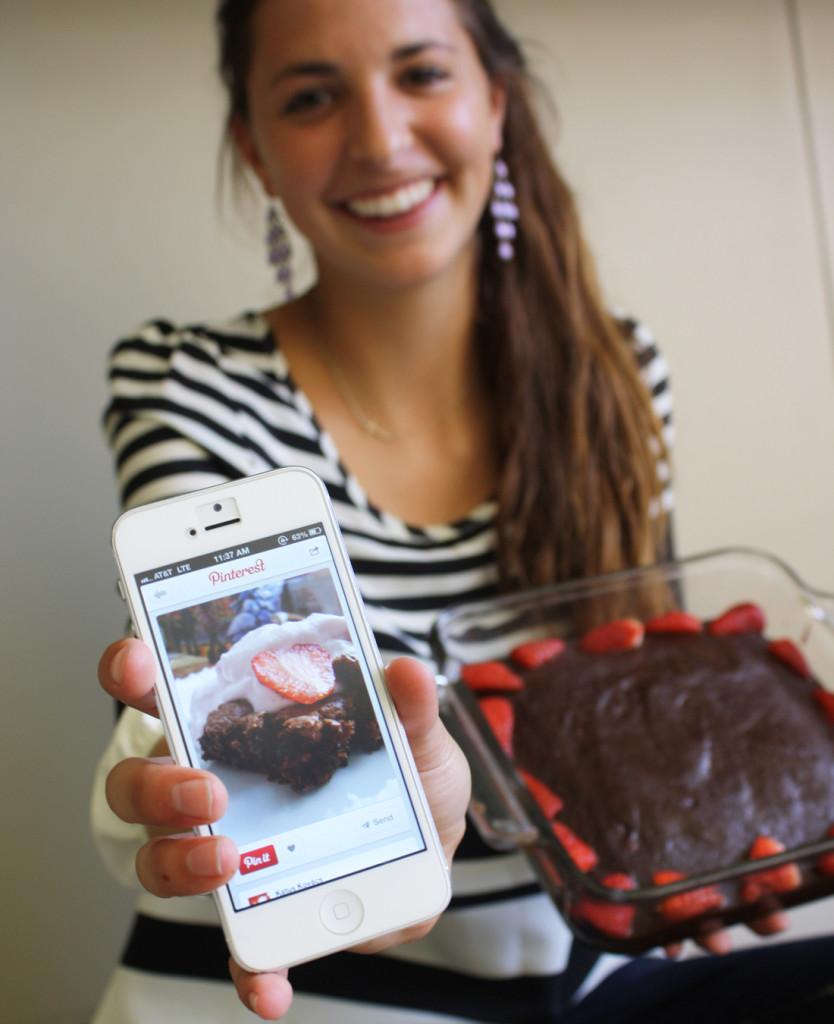 Junior Bailey Schimtt holds the chocolate/peanut brownies topped with fresh strawberries that she made from a recipe she recently found on Pinterest. She often searches different recipe “boards” to find new treats which she makes and shares with her friends, gives as gifts, or sometimes just saves as a treat for herself.