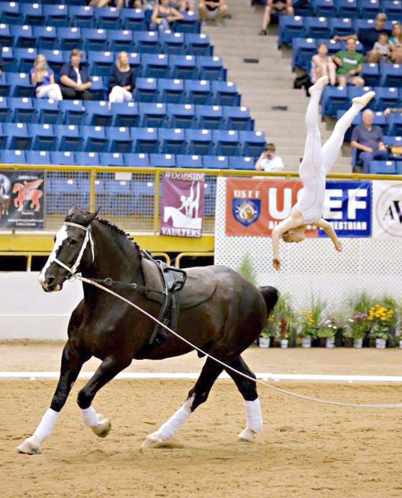 Junior Maya Leseten flips off her horse at the USEF/AVA National Championship horse vaulting competition in Denver, Colorado. She completed the flip and landed on the ground.