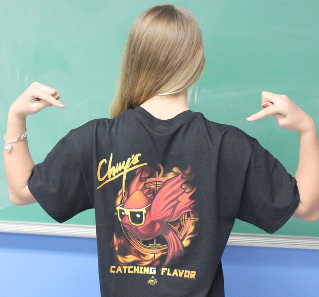 Freshman Kelsey Powers shows off her Chuys Hunger Games parody shirt. Powers plans to attend the midnight showing, which she bought tickets for two months in advance.