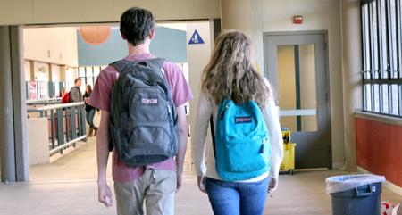 Jack and Jasmine Guy walk to class down the F hallway on campus. The two hold backpacks strapped to their backs filled with papers from their classes, pre-ap phyiscs, AP U.S history, pre-ap precal, AP spanish IV and AP english.