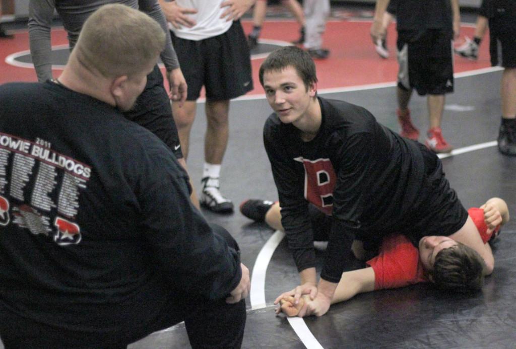 Coach+Glen+Lewis+critiques+senior+Logan+Zahn+as+he+practices+his+wrestling+moves+on+junior+Kemal+Kalimov.+Practice+takes+place+during+8th+period+and+after+school+on+B-Days.