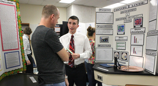 Senior Brian Jordan presented his science fair project before a judge. Many students underwent this process in order to be awarded for their projects.