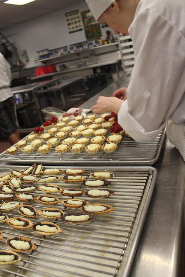 Culinary students prepare treats for the five-course meal they served. They started planning for Gourmet Night in September and finally served the food in March.