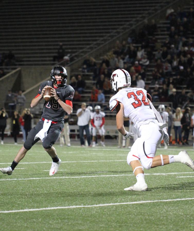 Game day: Senior Preston Wheeler gets ready to pass the ball down the field to make a touchdown  playing against Lake Travis. Bowie lost to Lake Travis at Burger stadium, ruining their six game win streak by a score of 64-7. The ‘Dawgs will now move on to the playoffs after last Friday’s game with Del Valle.  Photo by Granger Coats