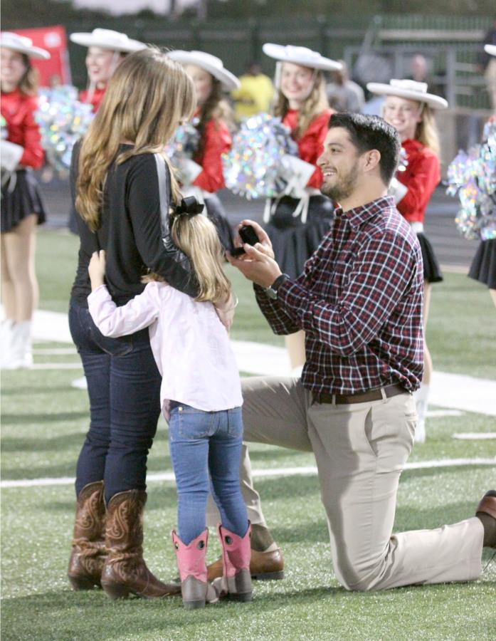 The big question: Trainer Pablo Rivera proposes to his girlfriend on the field at the homecoming game on October 18. With her daughter Isabella by her side, Christine said yes as cheering Silver Stars surrounded them and the band played celebratory music in the background. Photo by Hazel Rodriguez 