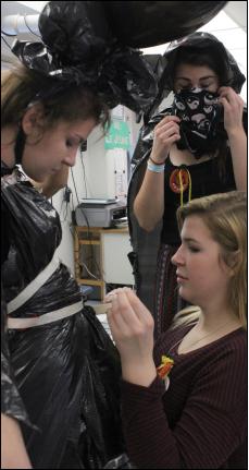 Art club president and senior Zoey Franz works to creat wearable works of art made of tape, trash bags and black balloons on various students. Franz and other co-president Alexis Williams plan out each activity the club participates in.
