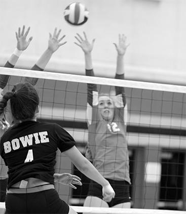 With a resounding effort junior Alex McLennan spikes the ball over an opponent. Bowie lost to Hays that night, but qualified for the playoffs. 