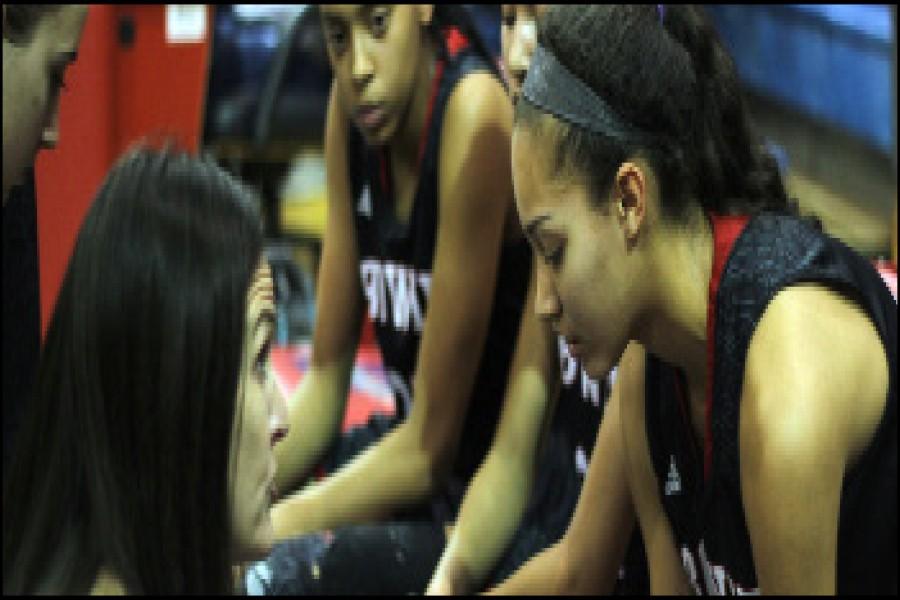 Girls varsity coach Vickie Benson calls a timeout to talk to the girls planning their next play. The girls were up against the Akins Eagles who they beat with a score of 72-56. 