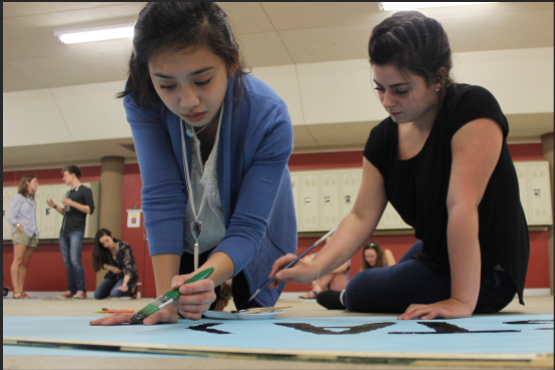 Juniors Lauren Do and Michelle Chahda paint posters with other PALS in preparation for Blue Out.  Blue Out is a day to bring awareness to child abuse and will be on April 22. 