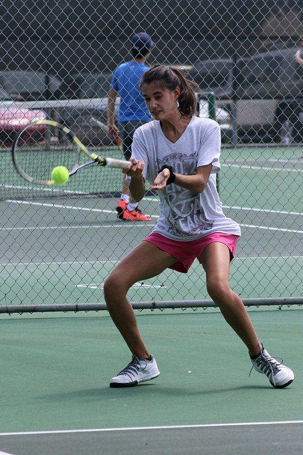 Jolie Francis returns the ball during her and Mariya Shkolnaya’s doubles team practice. The two have been training hard this season so that their dreams of going to state could happen. 