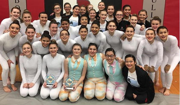 Wearing their costumes, Bowie’s Color Guard team gathers for a picture at their Annual Indoor Festival.  Photo from- @BowieGuard on Instagram 