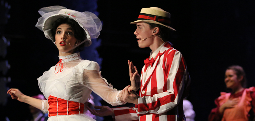 HOLIDAY WITH MARY: While taking a stroll in the park, “A” cast members, senior Maddy Sparkes and Blake Pousson, who play Mary Poppins and Burt, sing and dance to the song “Jolly Holiday” during the first act of the musical. Sparkes had always dreamed of playing Mary Poppins.”Mary Poppins is actually my dream role so getting to play that was like amazing, like is this really happening,” Sparkes said.  