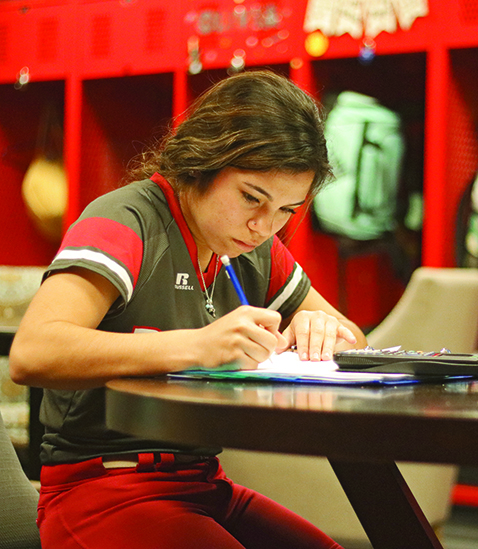 Senior Tiffany Licon does her math homework, using her time while she has it. Tiffany is a softball player and is one of many student athletes who has to miss school often because of games and tournaments.  