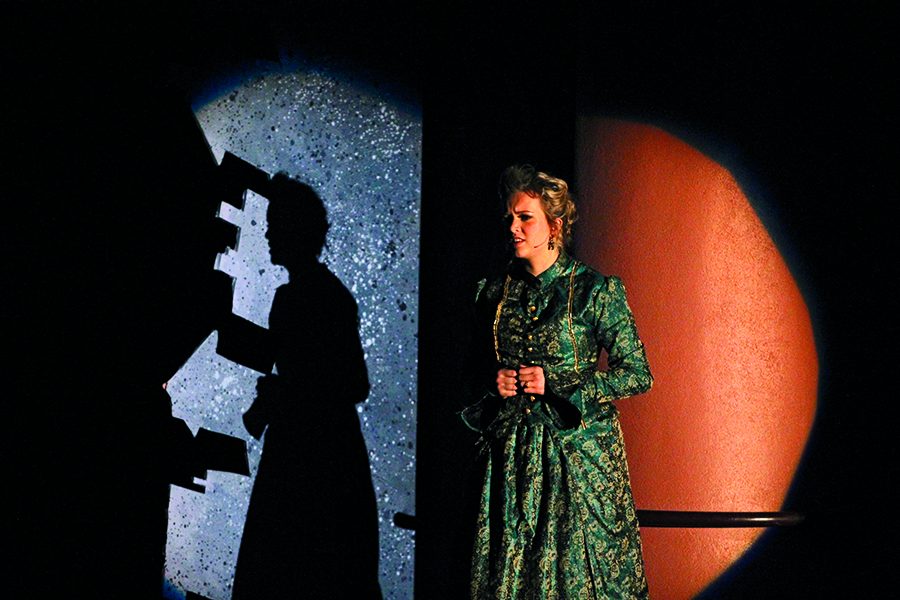 BEING MRS. BANKS: Playing Mrs. Banks is senior Piper Kopser who sings her solo ballad. Technicians prepare for the next scene.”While I was singing, the tech crew had to roll on the parlor set piece and some techies under the stage were setting up the fog machine for the next scene,” Kopser said.