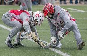 Senior KJ Howard wins a face-off in the cold against Colleyville Varsity.