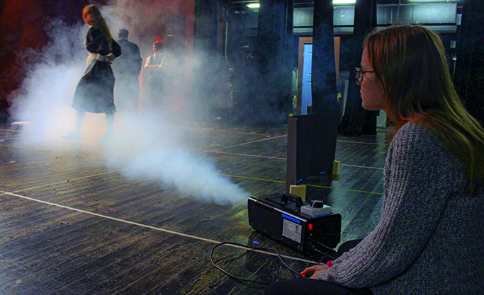 PROVIDING PIZAZZ: Alyssa Shumaker operates the fog machine to add  are to the UIL show, Violet Sharp. The Violet Sharp production cast and crews hard work did not go unnoticed at competition because they won several awards including the Outstanding Crew award.