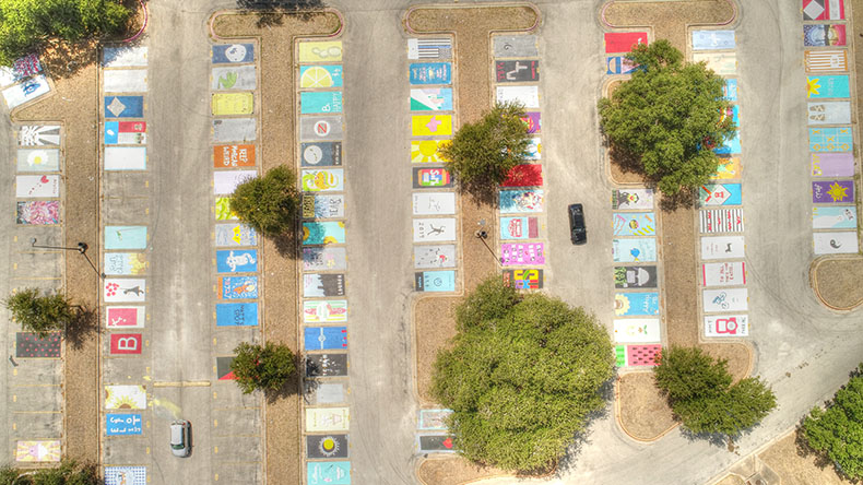 EXPRESS YOURSELF : The parking lot in front of Bowie features many painted spots that display the creative and unique minds of the senior class. Senior get the privilege of a parking spot if they meet attendance requirements and pay a $50 fee.