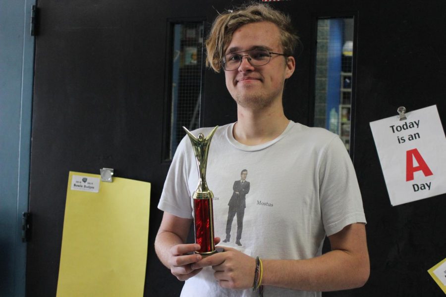 Greenhill Debate tournament competitor, Tate Weston with his Debate trophy.