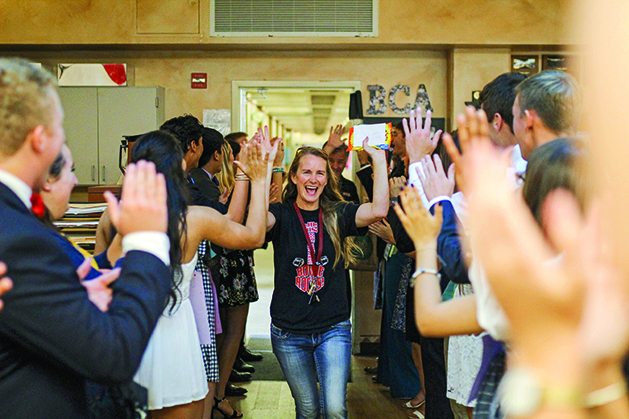 FULL OF JOY: Math teacher Kelly Flickenger makes her way down the aisle of Bowie PALs students as she enters the secret PALs reveal party. The PALs lined up and waited for their teachers to come in so they could surprise them. “It’s one of the things that the PALs do which teachers truly appreciate,” Flickenger said. “I like this idea that Garcia does and it really let’s his kids get creative with different ways of thanking their teachers.”