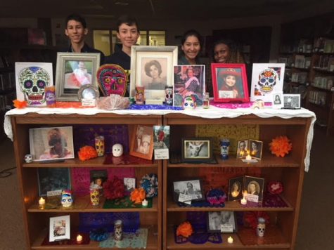 (Left to right) Philip Weiss, Alex Araiza, Sandy Benitez, and Cyn Torrey Smith are members of the Spanish Club and have worked together to create an Ofrenda in the library to commemorate the loss of loved ones known by the Bowie faculty and staff.