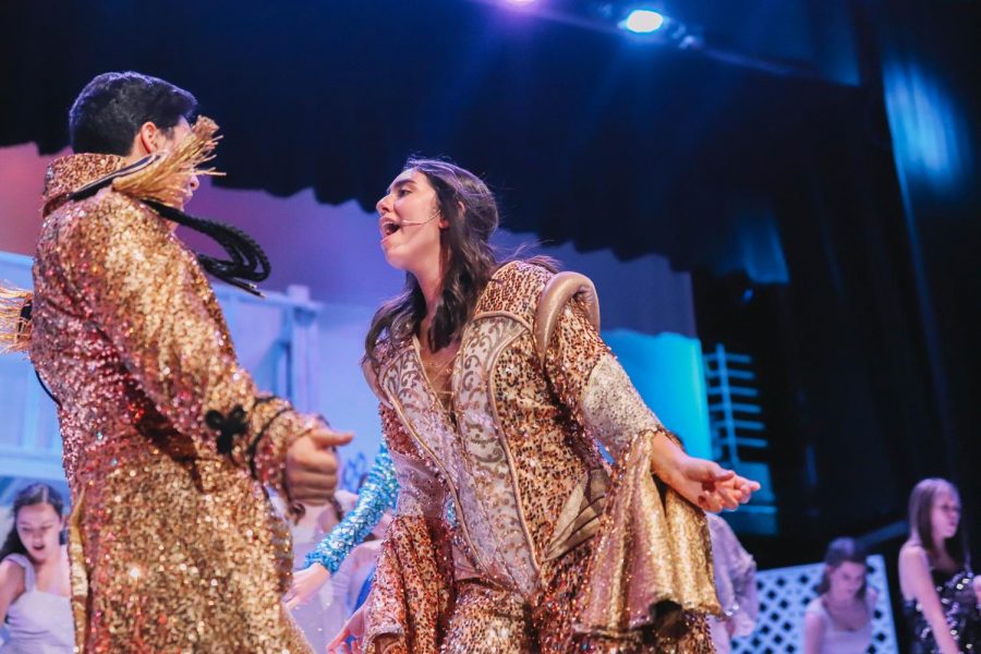 Eric Larson (Left) and Kamryn Morales  (Right) perform Mamma Mia in their breathtaking gold costumes 