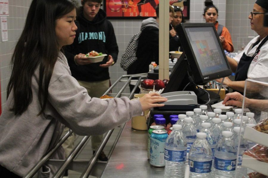 Junior Kaitlyn Luu orders her lunch from the Bowie cafeteria, which some students have dubbed to be too expensive.