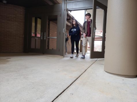 Freshmen Sophie Cabrera (left) and Preston Savoy (right) exit through the doors that had been vandalized on December 13th. The doors and windows at Bowie, now repaired, were fixed using donations from the Bowie PTSA's fundraiser.