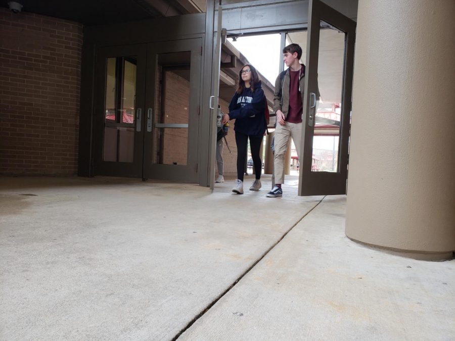 Freshmen Sophie Cabrera (left) and Preston Savoy (right) exit through the doors that had been vandalized on December 13th. The doors and windows at Bowie, now repaired, were fixed using donations from the Bowie PTSAs fundraiser.