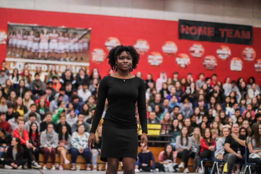 Seun Odufuye walks down the center of the gym down to her seat alongside other members of the JBHS multicultural awareness club. The MCAC worked all year to promote unity.