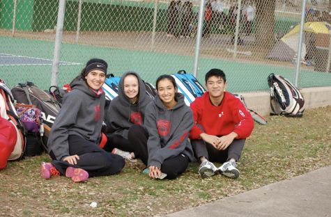 Waiting in anticipation: Emily Leeke, Kayleigh Shumaker, Sydney Johnson, and Stephen Do huddle together in the cold while waiting for their next match at UT Whitaker courts.
