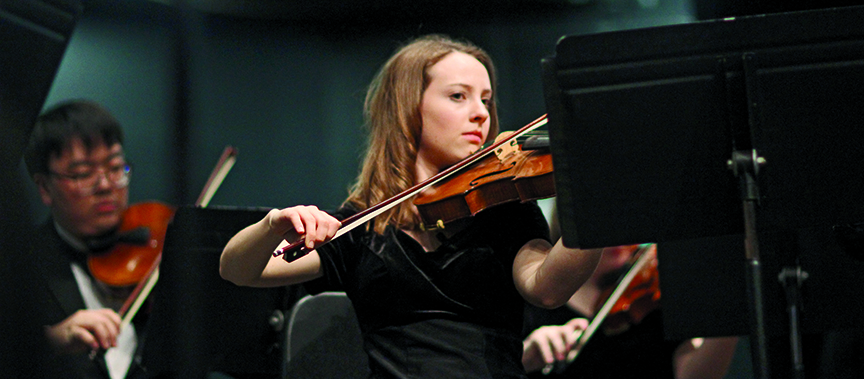 SKILLFUL STRUMMING: Grace Gum plays her viola in the orchestra winter performance. The orchestra performed pieces from Borodin’s Second Symphony and Finlandia by Sibelius. 