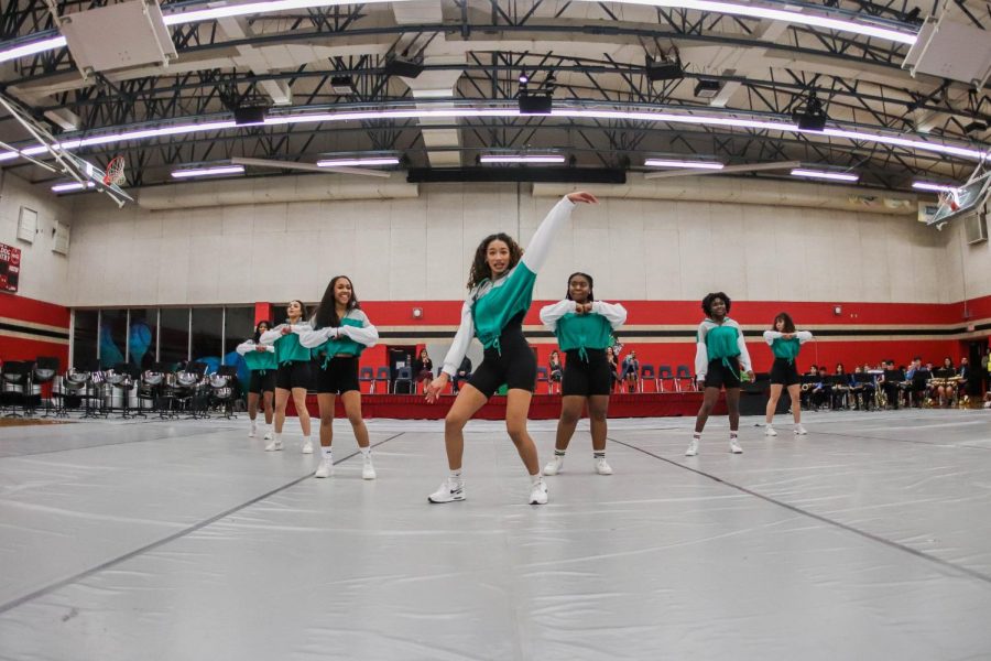 (Left to right) Kiara Gonzales, Kaeleigh Chambers, Lisa Wilkerson, Nyah Bernucho, Camron Sneed, Seun Odufuye, and Gia Spencer dance as part of the Multi Awareness club for hundreds of students  in the JBHS Black History Month assembly in front of the main podium. Both gyms were open for the event, with the performance covering the small gyms floor while students are seated, elevated in the larger gym.