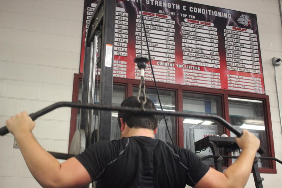 POWER AND DETERMINATION: Junior power-lifter Evan Janacek performs lat pull-downs. Janacek is currently ranked as one of the top lifters at Bowie. 