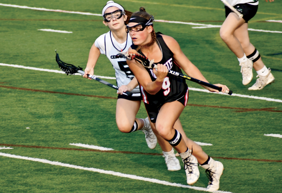 ON THE MOVE: Junior Sydney Heim sprints down midfield towards the goal. Heim was awarded with All-American and All-State honors this season. 