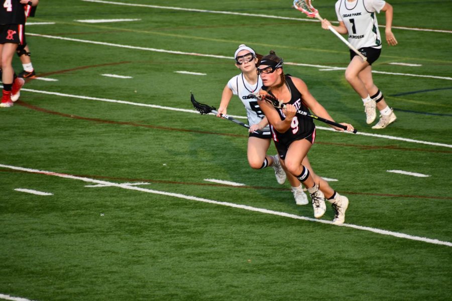 ON THE MOVE: Junior Sydney Heim sprints down midfield towards the goal. Heim was awarded with All-American and All-State honors this season.