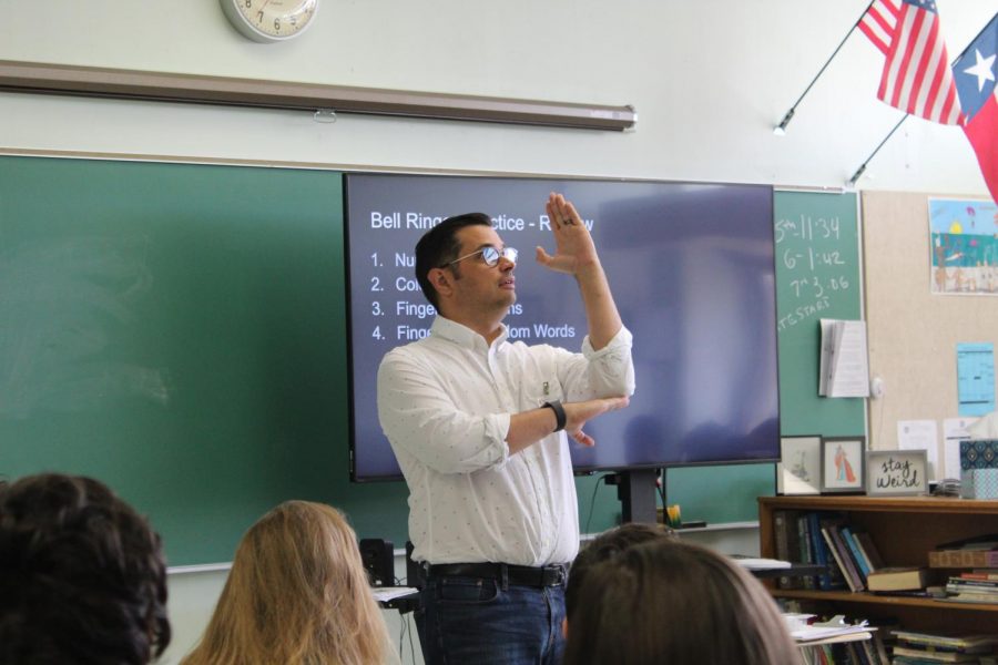 The new ASL teacher, communicates with his students using American Sign Language. 