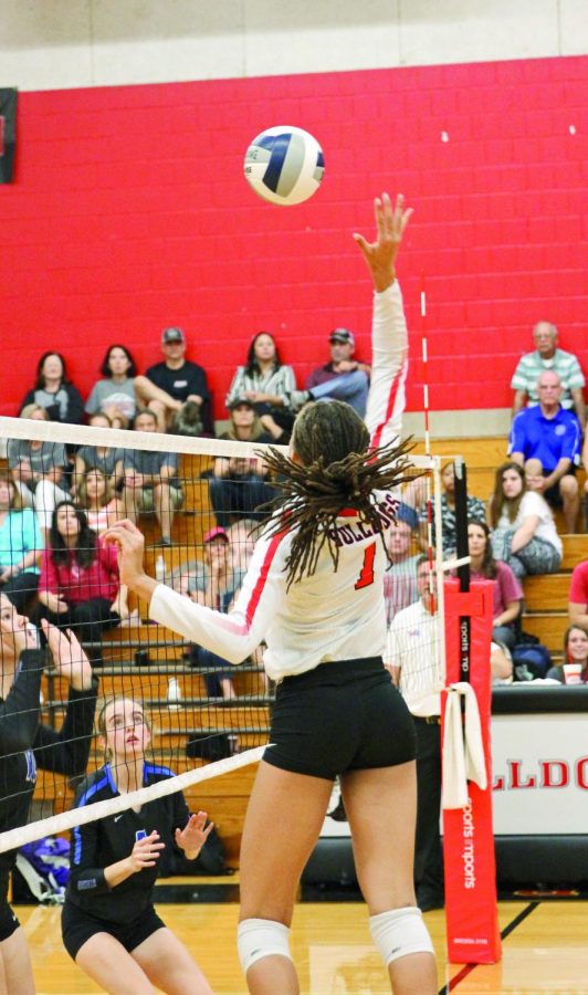 BUMP, SET, KILL: Junior middle blocker Maya Johnson hits the ball back on to Ann Richards’ side of the court. Because of her performance, she has received interest from several colleges. 