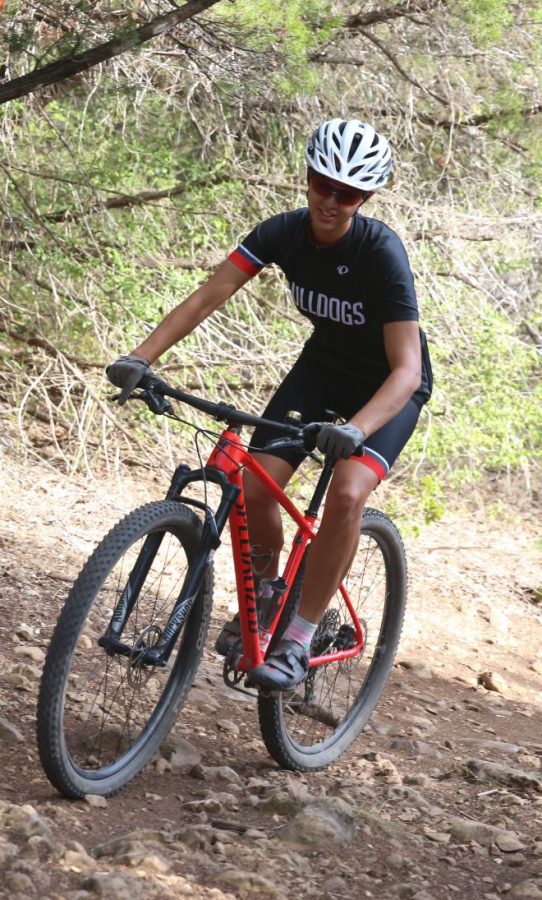 ROCKY ROAD: Ann Richards senior Emily Doucette navigates her way through the rough trail on her bike. Doucette wears special shoes, padded shorts, a helmet, and glasses to help keep her safe while she rides.