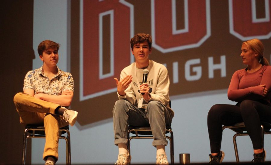 SPEAKING ASSERTIVELY: Seniors Chris Lamm (left) and Erin Rannefeld (right) watch as senior Samuel Hayek (center) speaks about the importance of the role of seniors on campus. Seniors attended an assembly while other grades took the PSAT on Oct. 16.