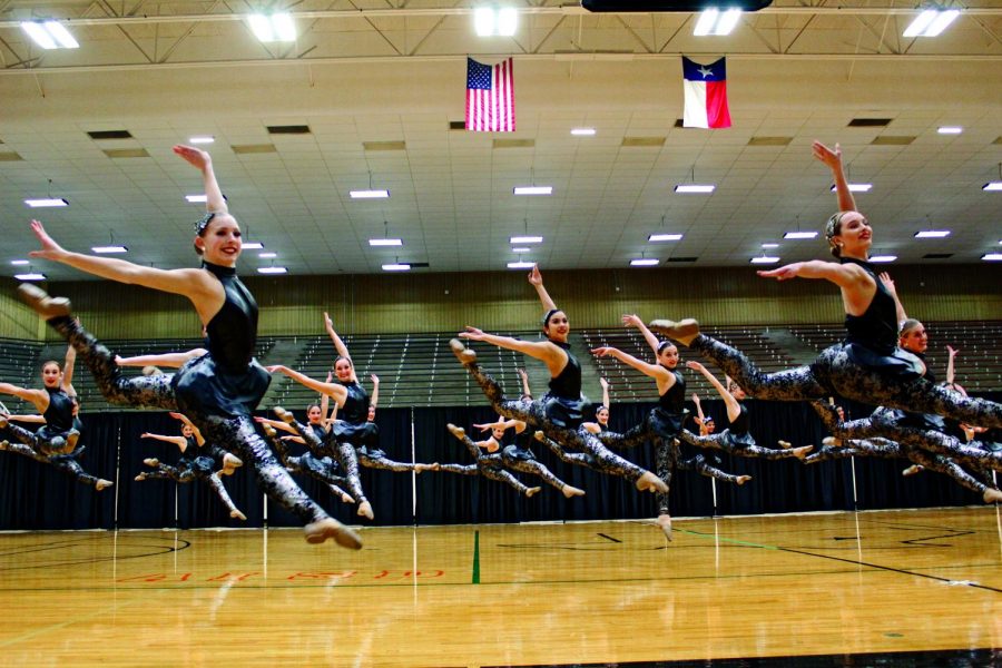 FLYING HIGH: The Silver Stars jump into a fire bird in the middle of their team jazz. The team has been practicing this piece since early December.