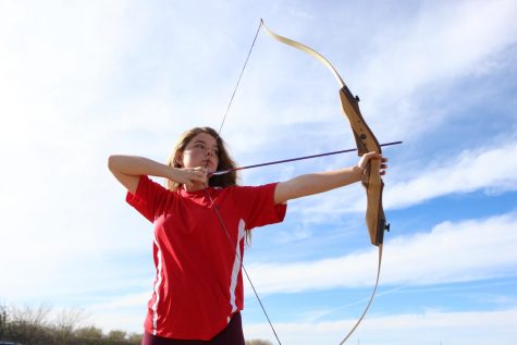 Student teaches archery classes