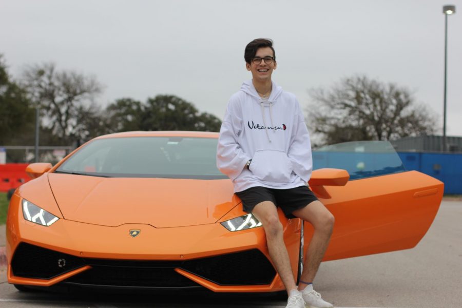 KICKED BACK: Senior Ethan Ramirez poses in front of his father’s orange Lamborghini. Although Ramirez does not drive the Lamborghini to school for saftey reasons, he does drive a 2005 Toyota Tacoma truck. 
