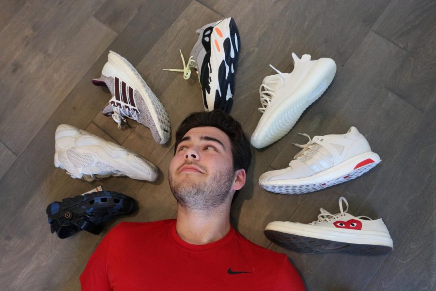 EYES UP: Junior Blake Guerra glances at his growing collection of shoes he plans to sell. Guerra’s reselling business focuses on selling what is commonly bought or trending in the market. 