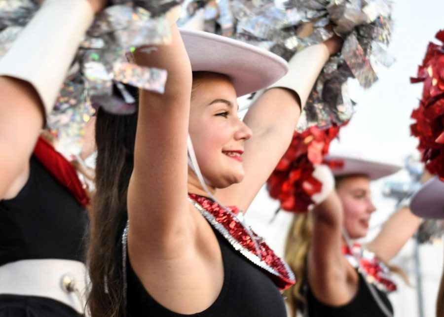 Sophomore Keira Folkers cheers alongside her Silver Stars team at a Bowie football game. As a member of the Silver Stars dance team, Folkers has to participate in three online workouts each week to prepare for the fall season.
