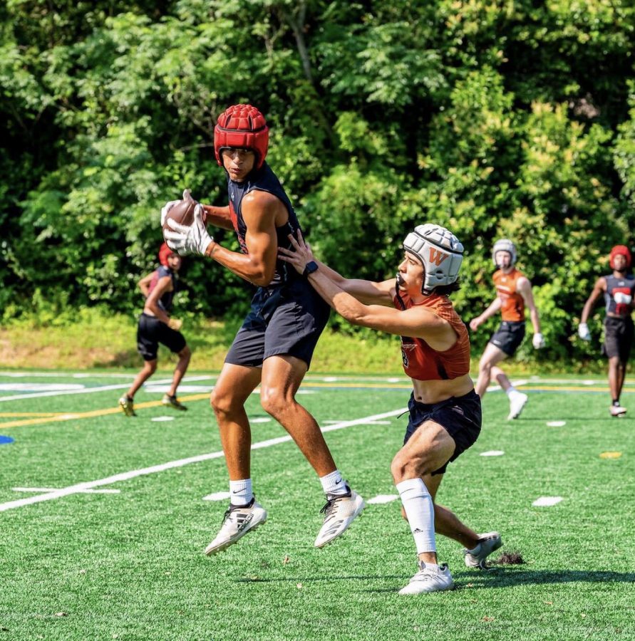 Junior varsity wide receiver Thanio Bright (left) receives a pass. Follow @thaniobfit on Instagram to stay updated on his athletic journey. 