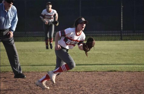Senior Emily Lear runs across the field with her eyes on the ball. She played middle infield and outfield on varsity before the season was cut short.
