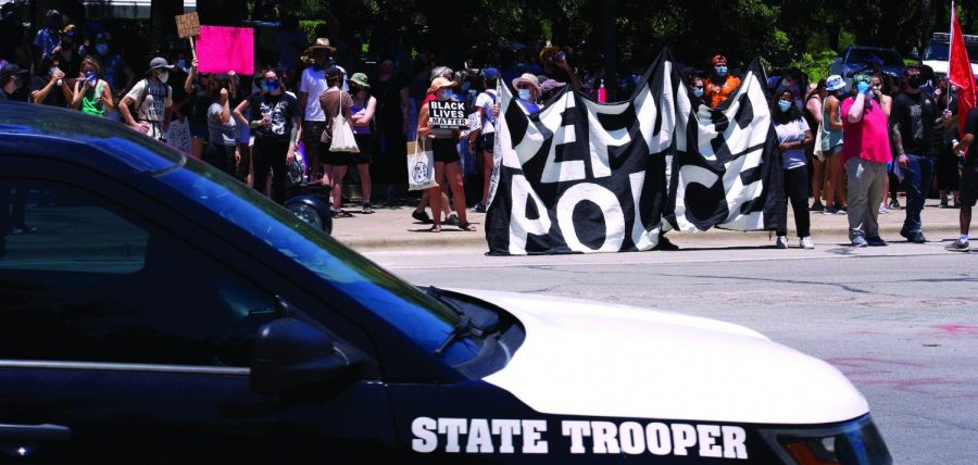 CITYWIDE TENSION: State Trooper patrols Black Lives Matter protest in Austin. In August, the City Council voted to reallocate one-third or $150 million of the $434 million initial APD budget. 