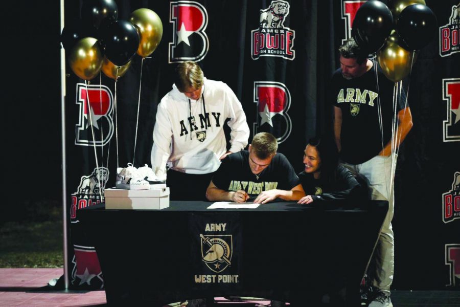 OFF TO THE BIG LEAGUES: Coleton Benson officially signs to Army West Point for basketball as his family gathers around to watch. Benson has been playing basketball for the majority of his life and is excited to be able to continue his career at the college level. 