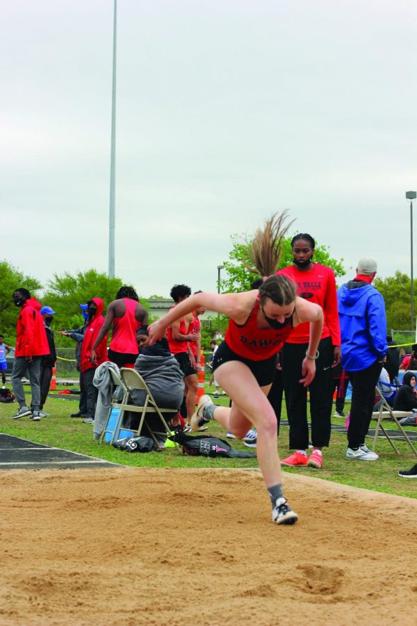JUMPING FAR: Senior Abbey Smith completes a triple jump in the district track meet. Coach Benson specializes in coaching this event along with long jump and has helped these athletes place at this district meet. 